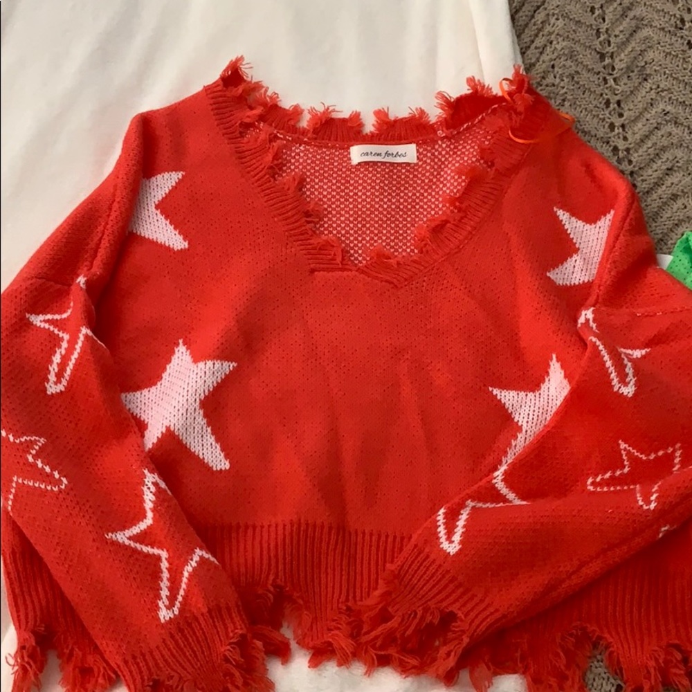 Pink star sweater with distressed edges